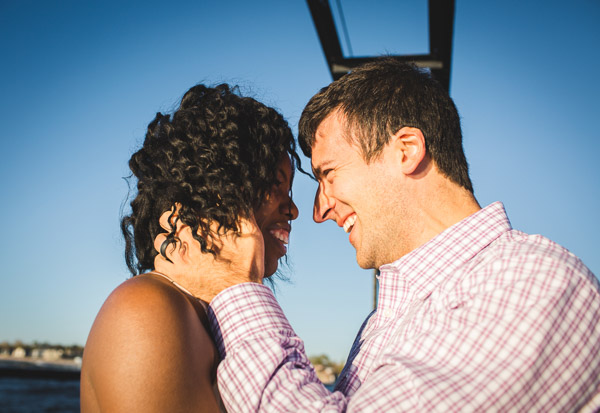 side close up portrait of couple on pier in golden sunlight 