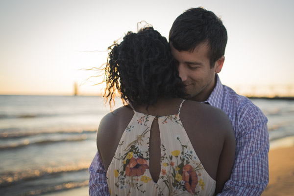 loving embrace of couple on beach, man smelling his wife's hair