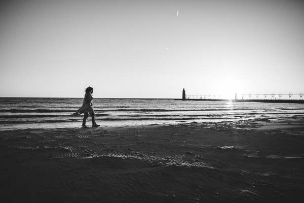walking along beach with movement of scarf, emotional, black and white