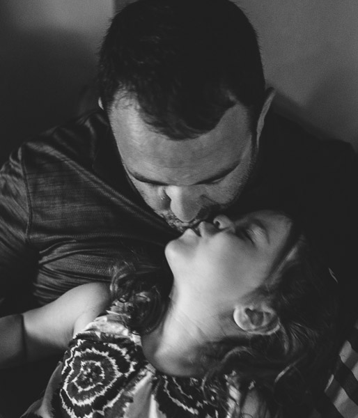 father kissing his daughter, black and white 