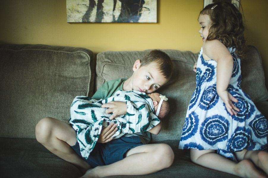 sibling interactions on the couch in morning light 