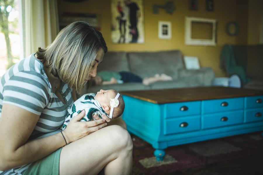 mother kissing her newborn child in compassionate love