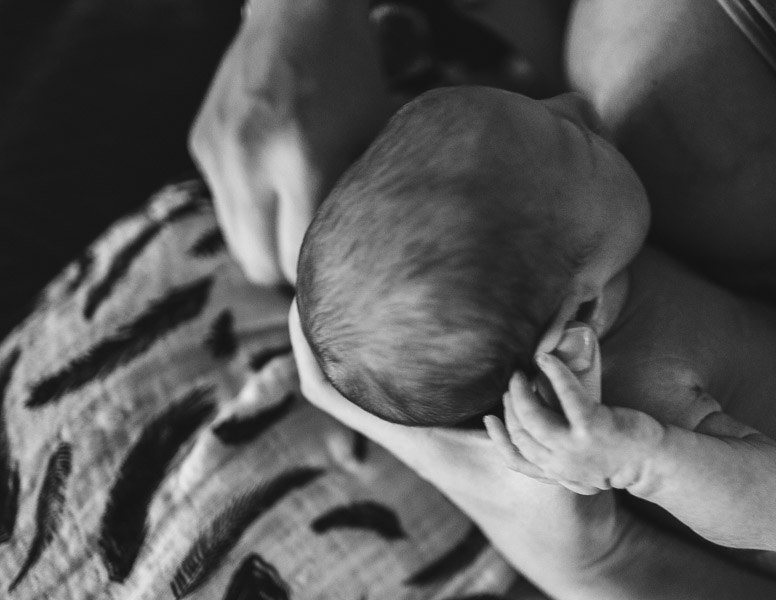 details, mother cradling newborn baby's head while breastfeeding, connection 