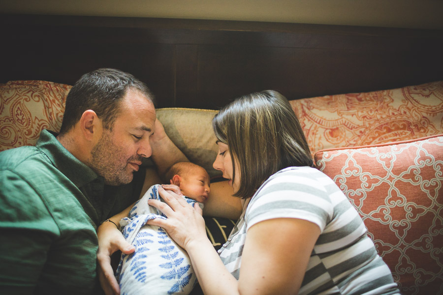 mom and dad connecting with newborn child 