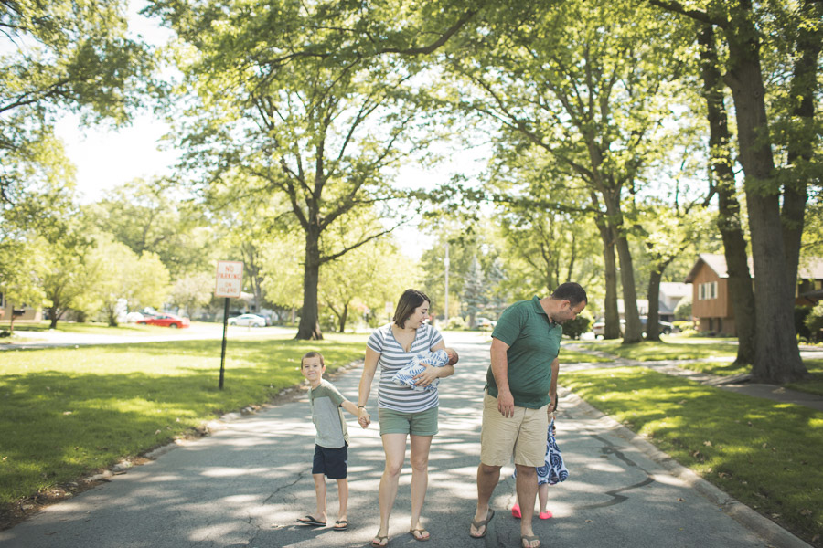 family walking down street, hand in hand, connecting in beautiful soft light 