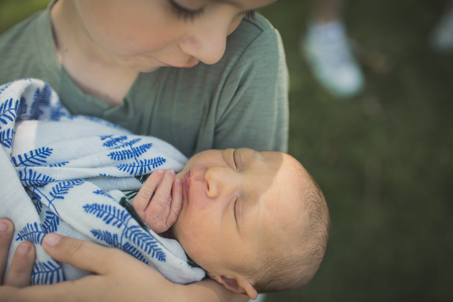 brother cradling baby sister, connection, powerful portrait 