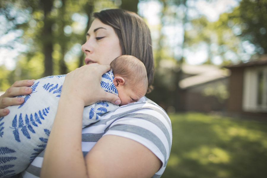 mother with newborn child snuggled on her shoulder, connection, powerful, caretaker 