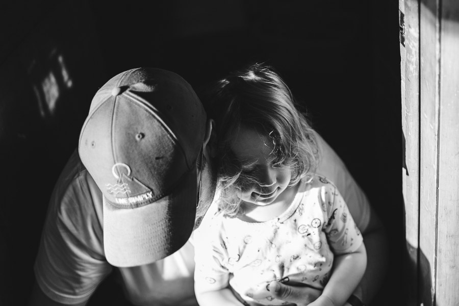 Daughter sinking into father loving embrace, warm connection
