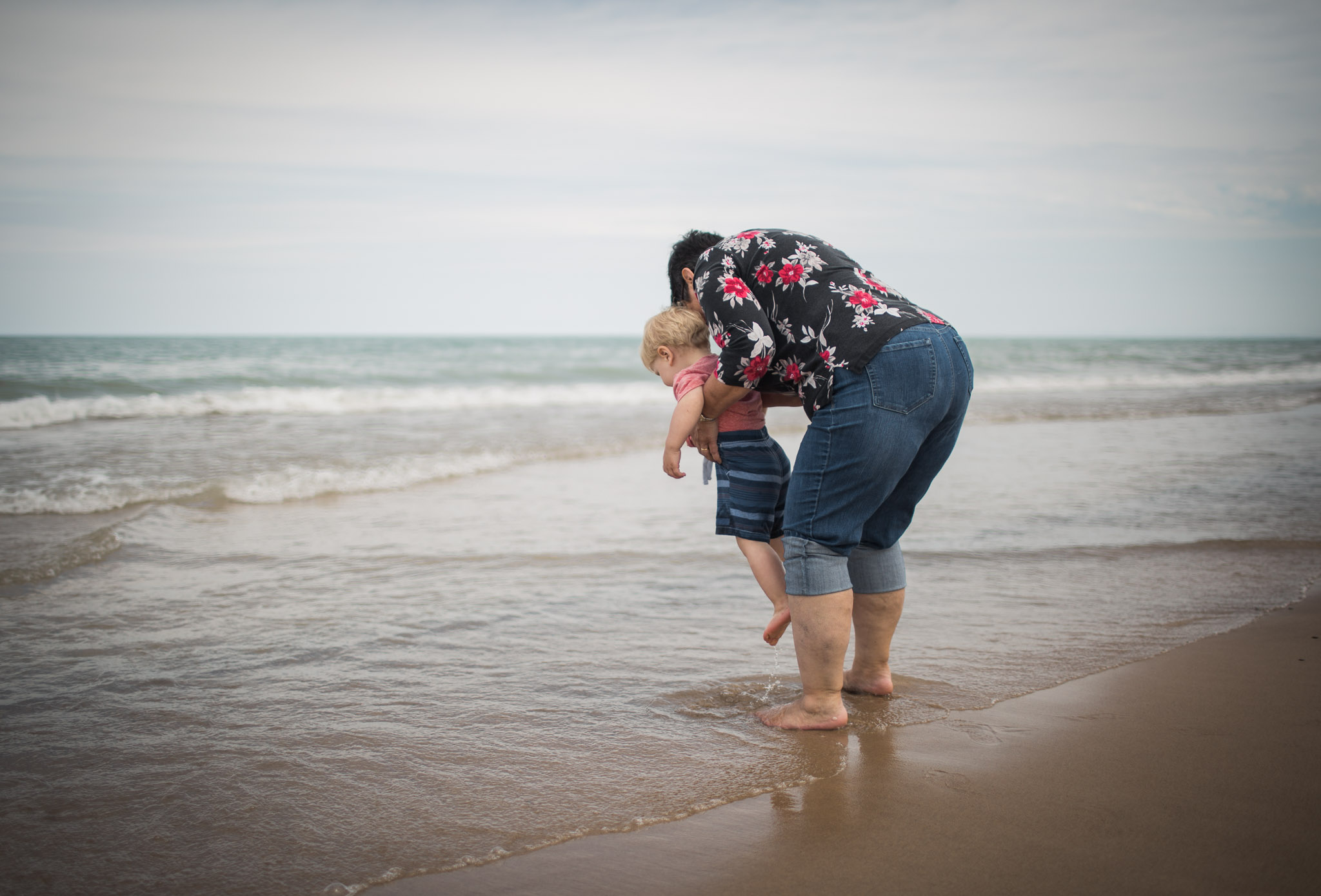 Little boy exploring the ocean with grandma, Family Lifestyle Session off of Lake Michigan