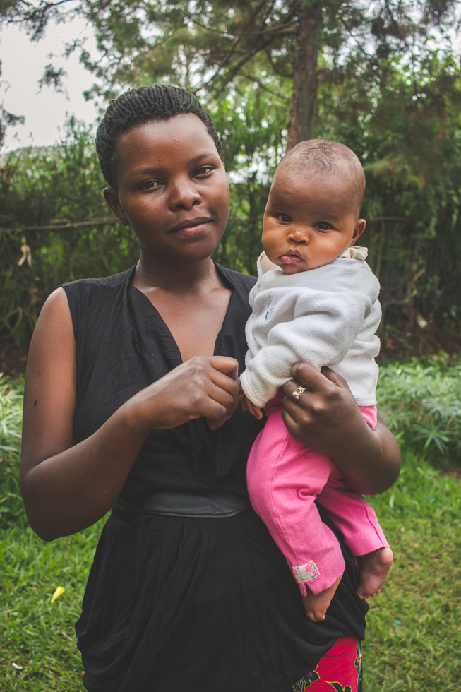 Mother holding her baby girl, warm embrace, connecting 