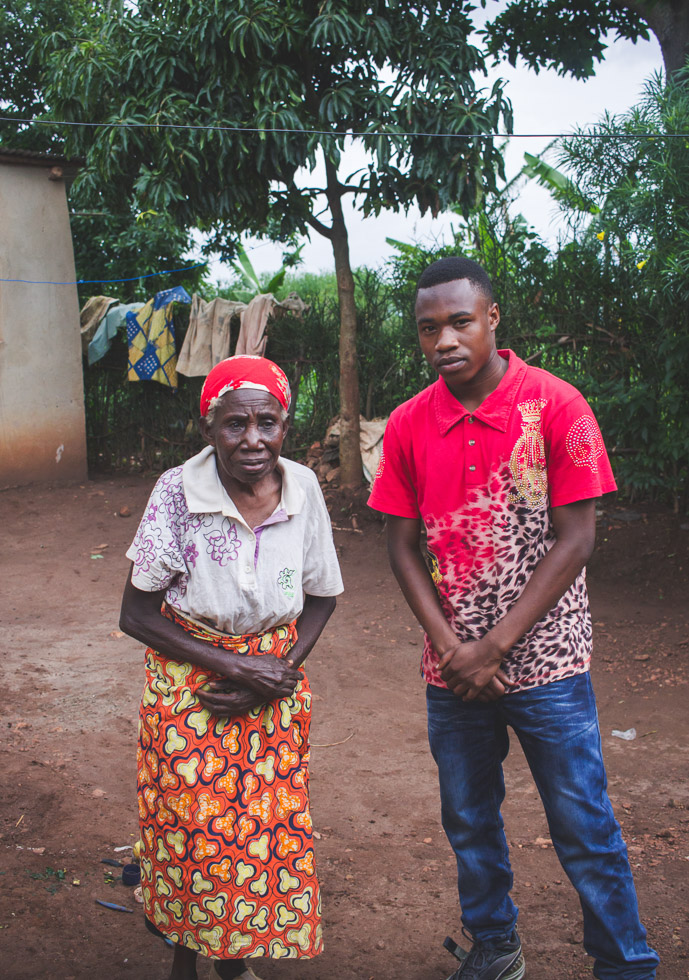 Portrait of grandmother with grandson outside home Africa 