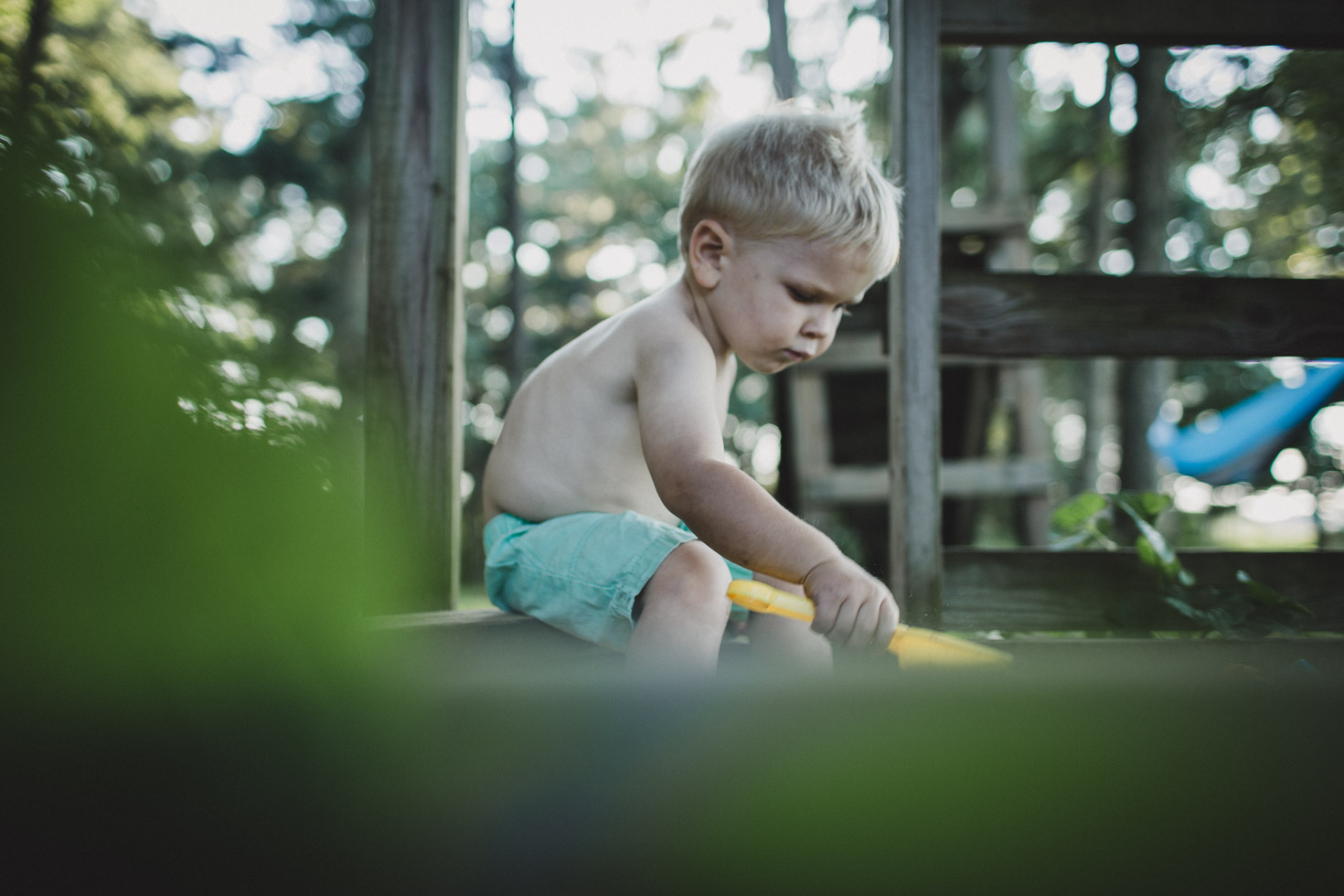 Layered image of boy playing in sandbox