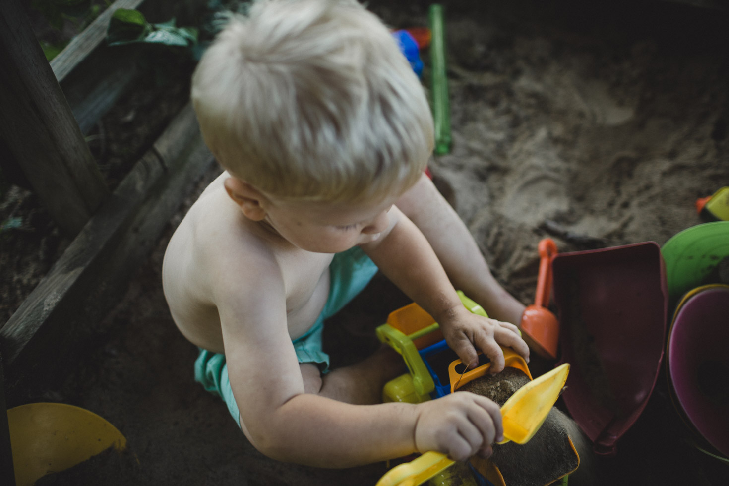 documentary overhead portrait of boy playing in the sand