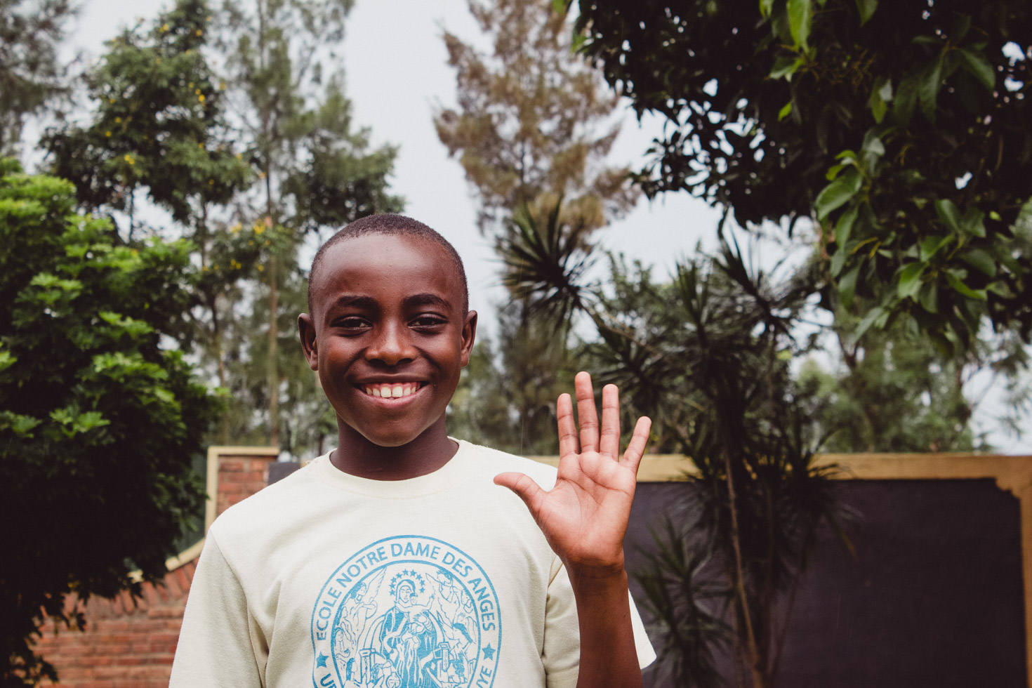 Student waving at an academy in Rwanda 