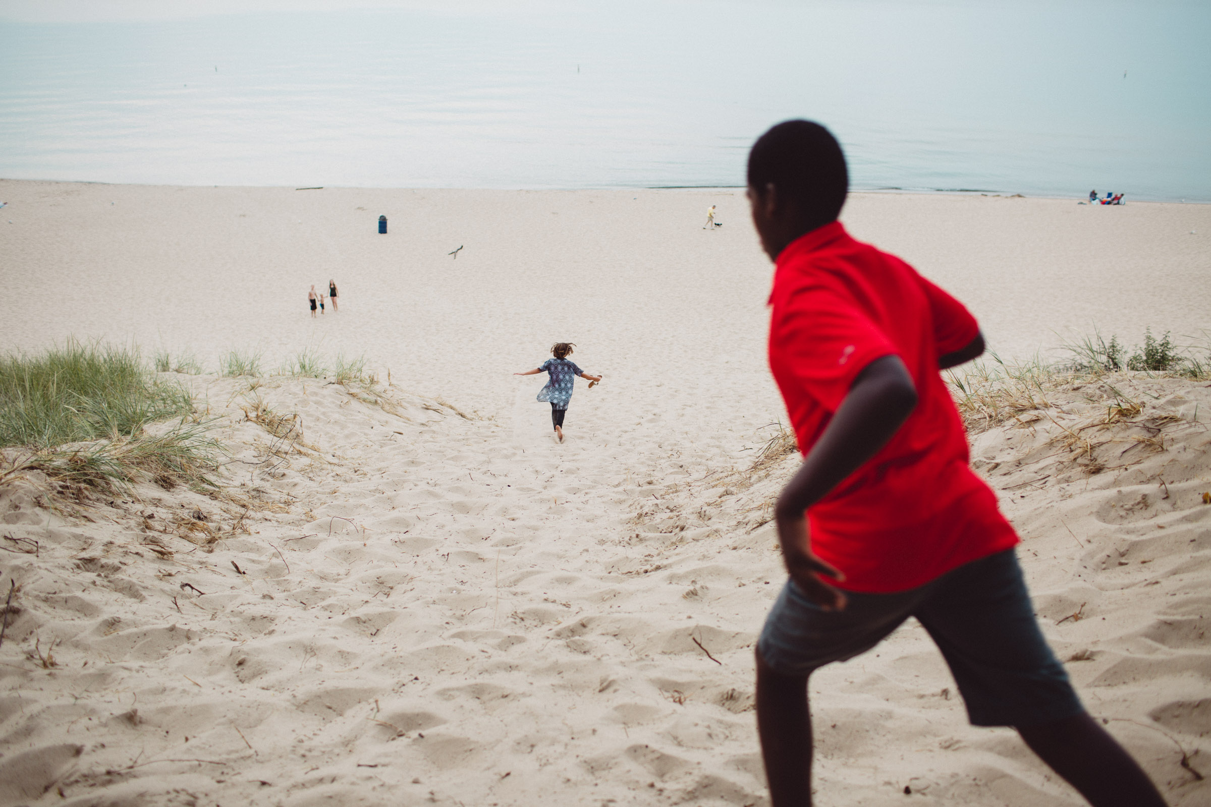 children running down sand hill 