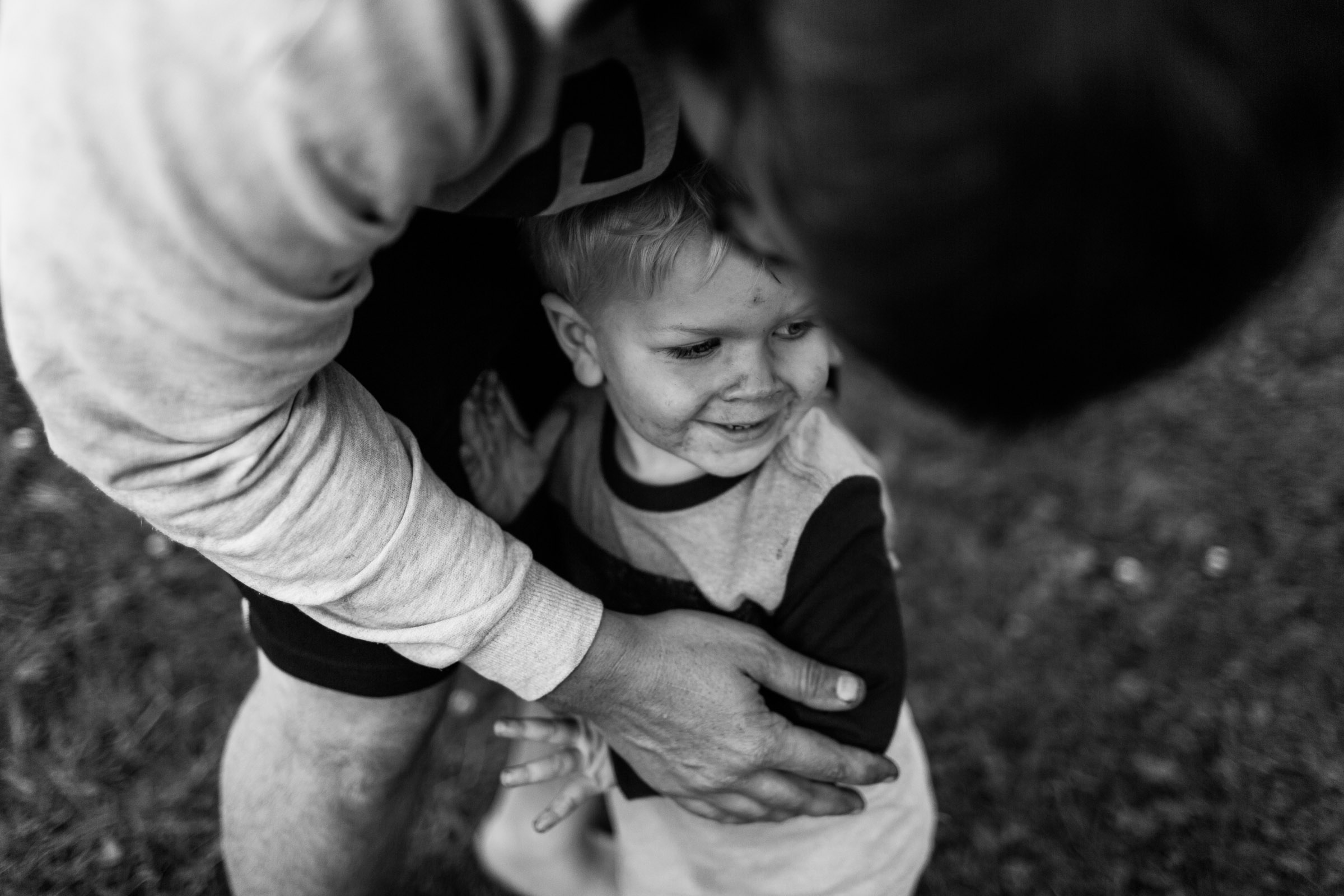 son snuggling up on father's leg 