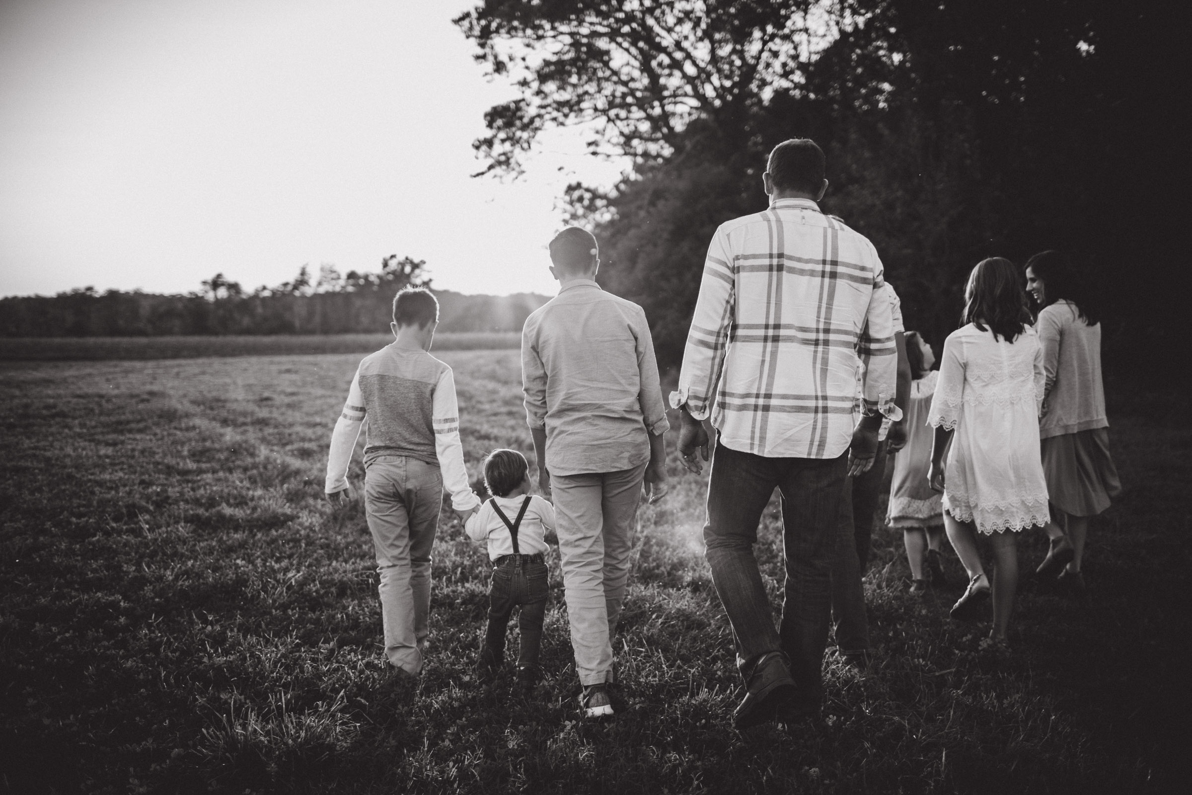 family walking together in field, BW 