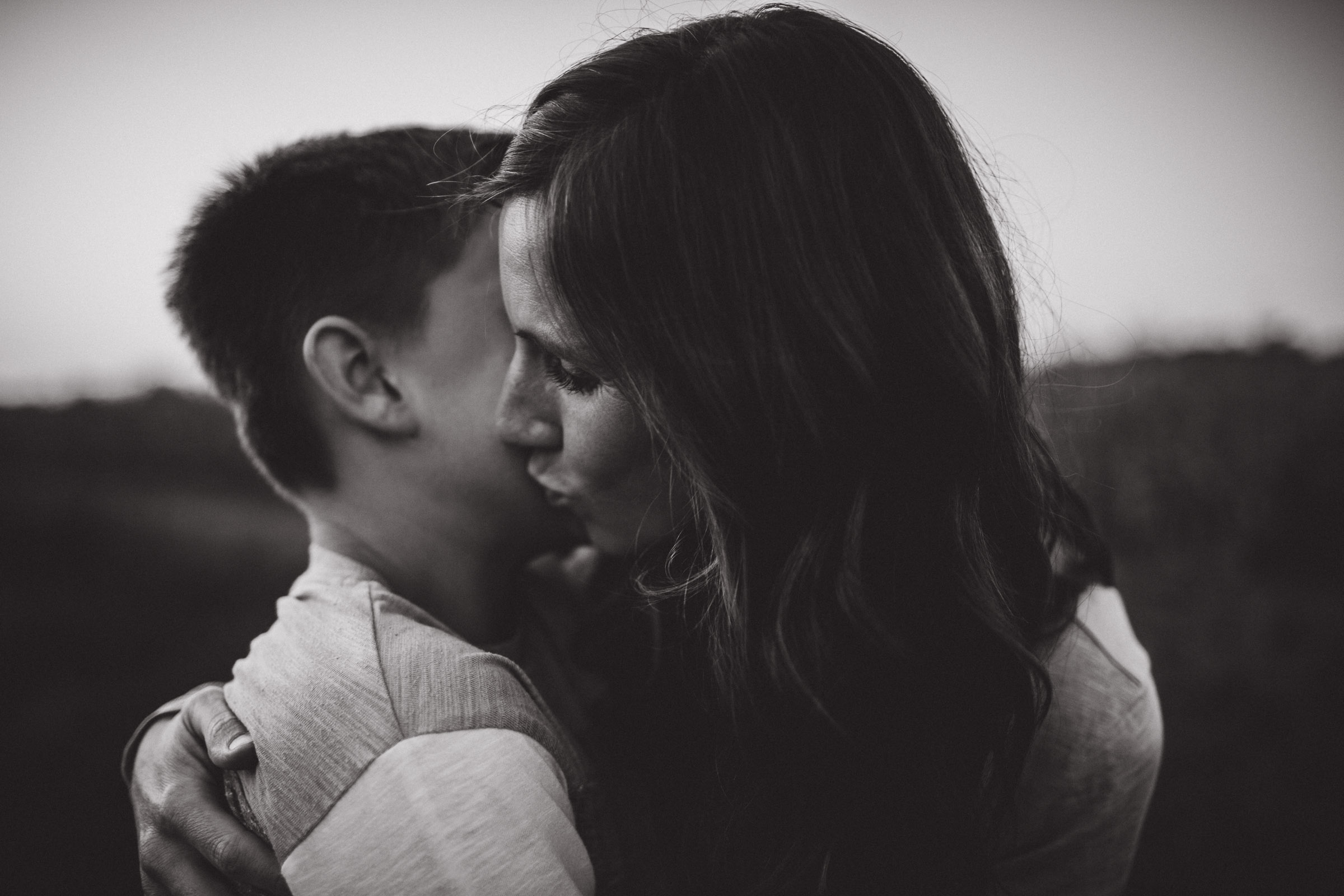 portrait of mother kissing her son, BW 