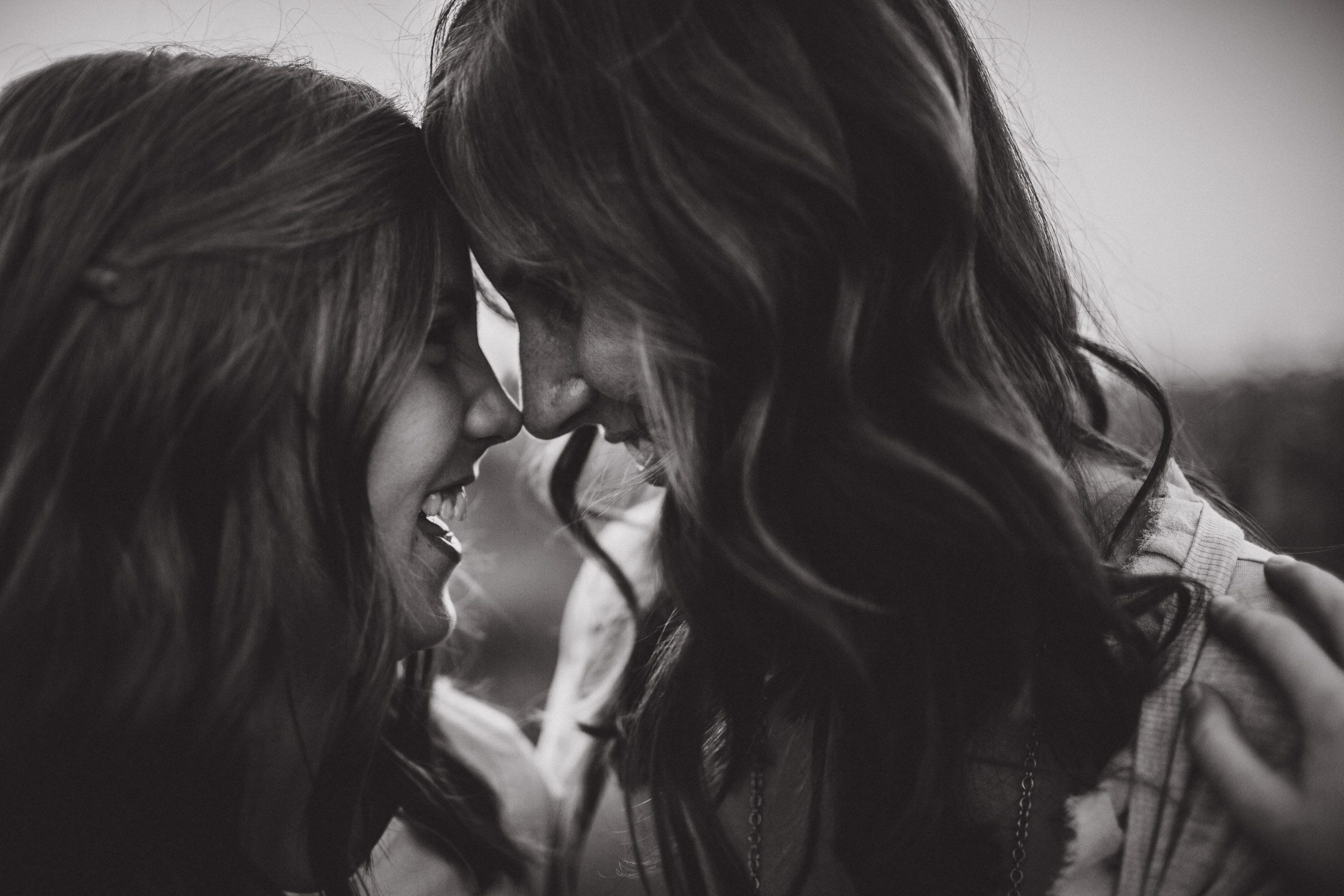 mother and daughter connecting with noses, black and white portrait 