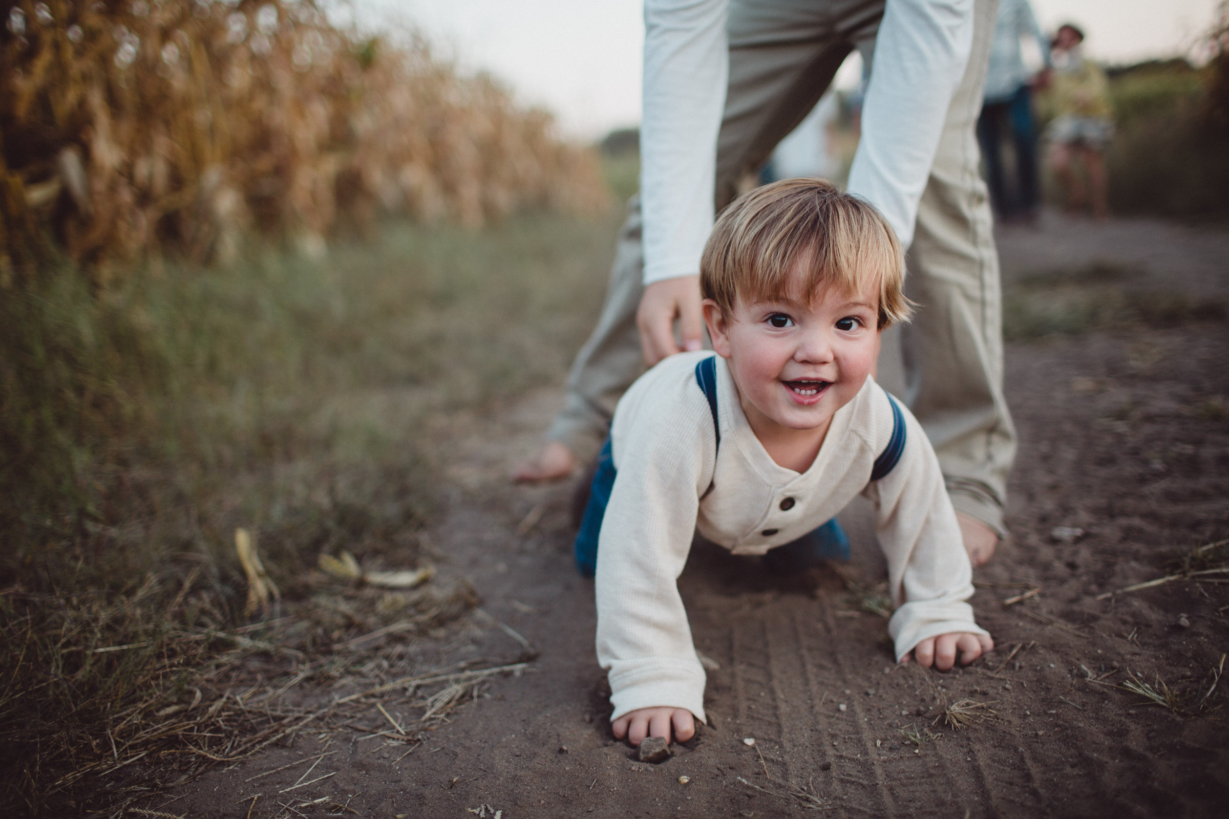 toddler looking into camera as he crawls towards it