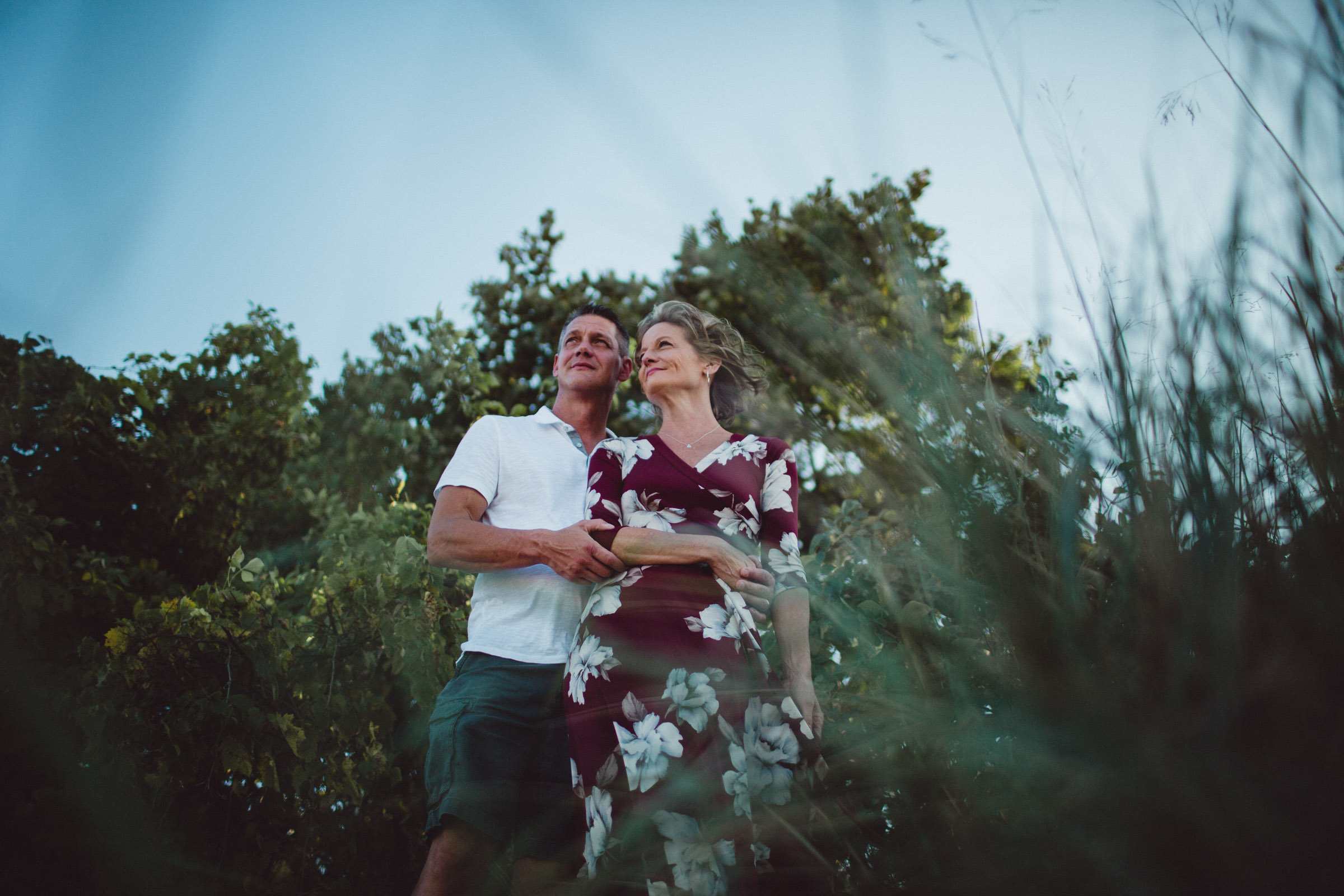 Layered image of couple shot through bushes 