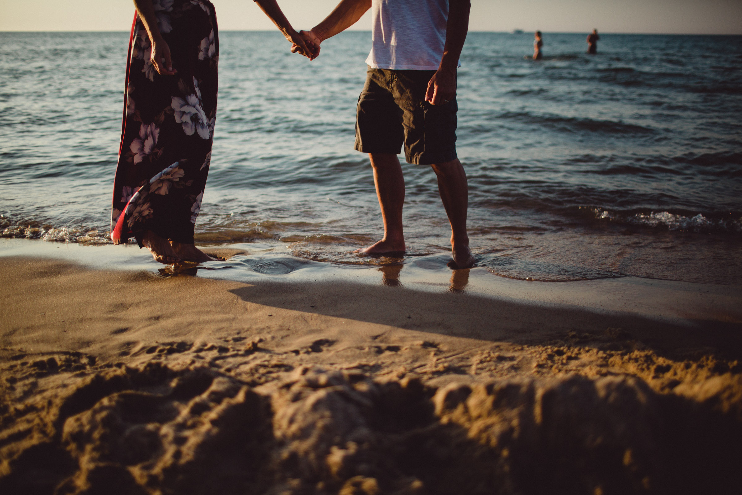 portrait of couple holding hands on the beach 