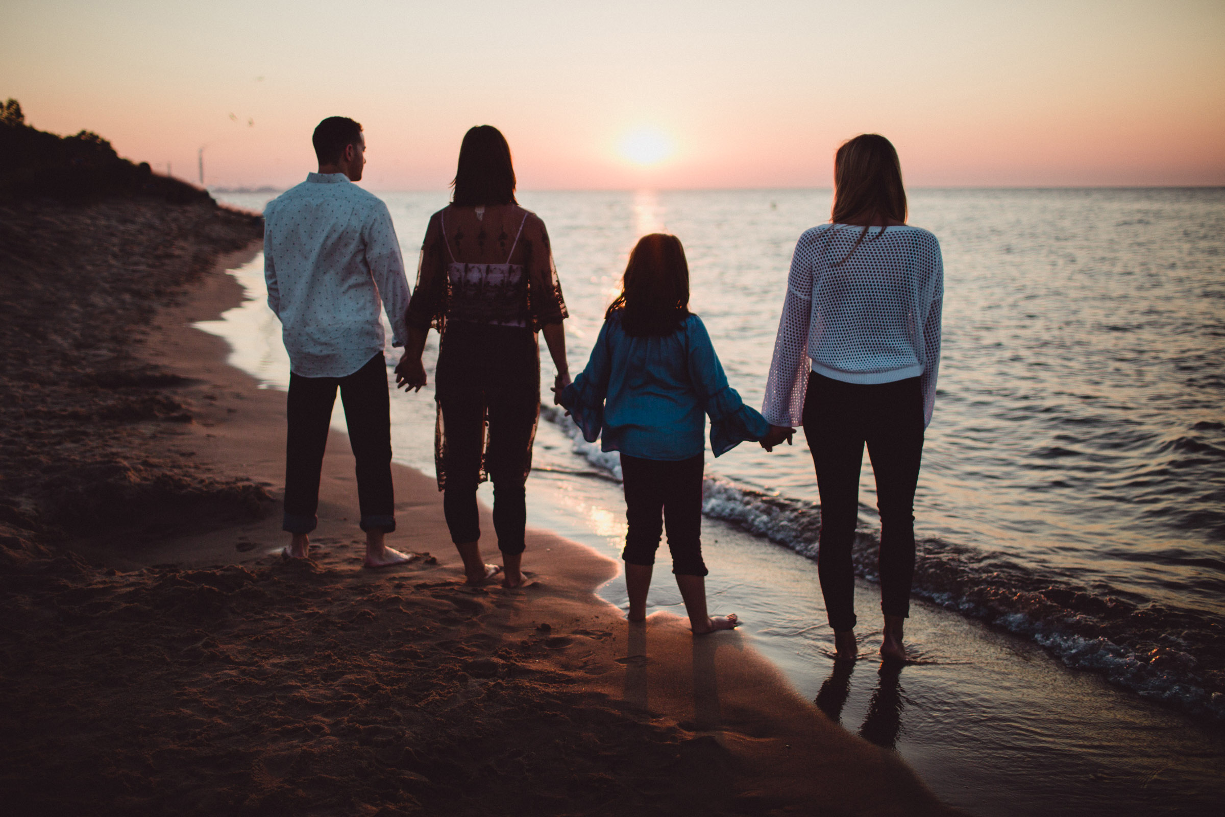 siblings silhouette image on the beach 