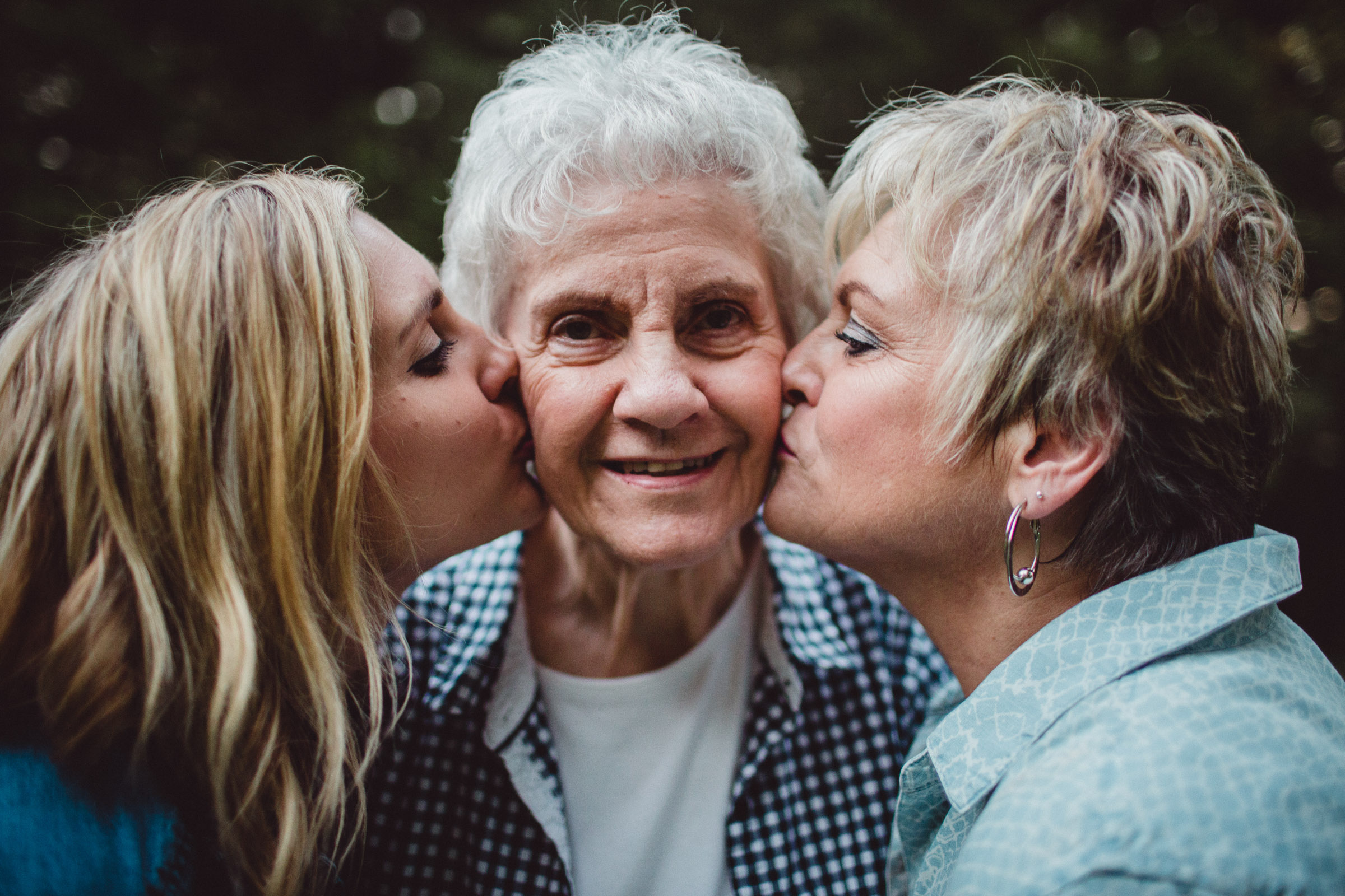 3 generations kissing on the cheek 
