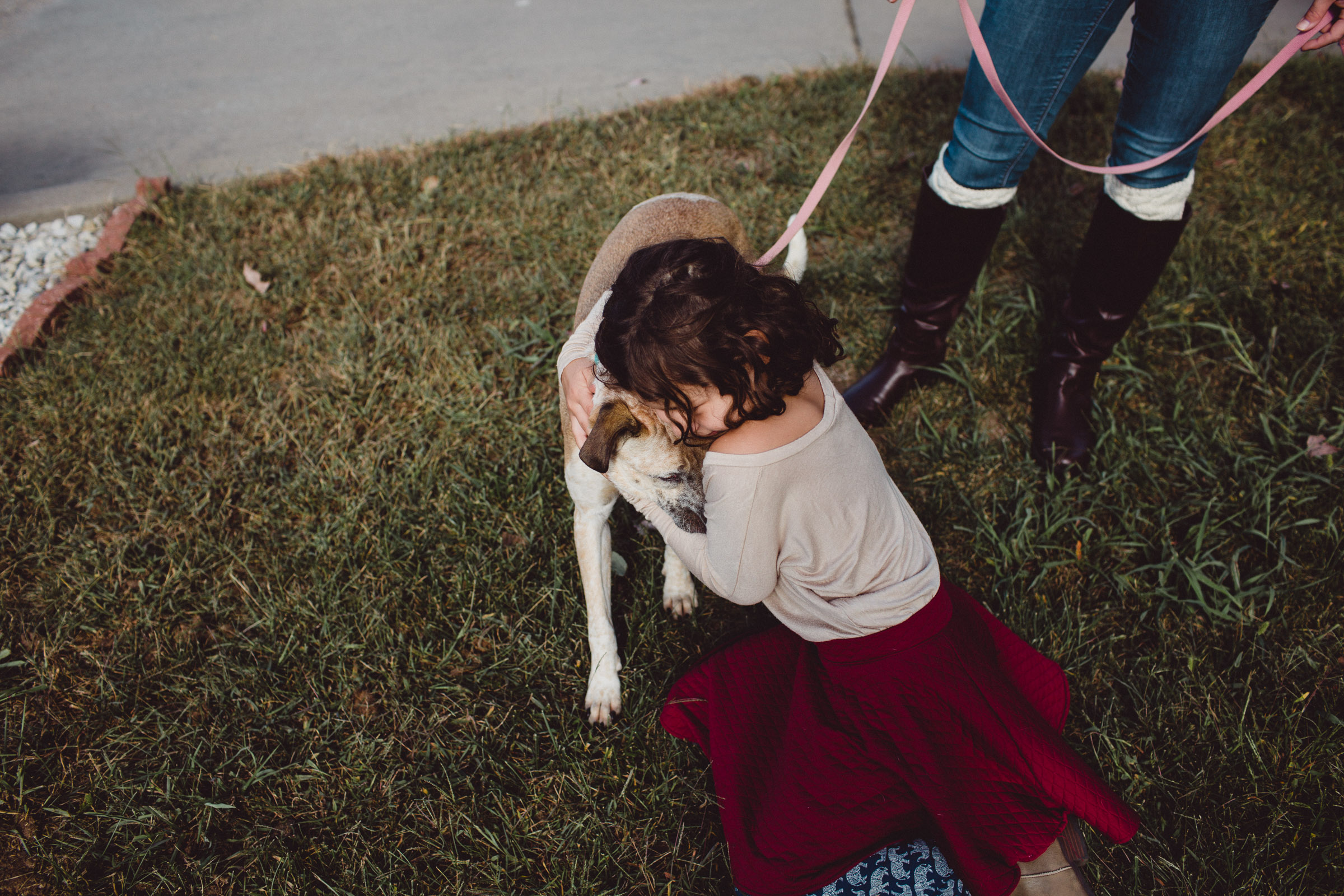 girl loving on her dog 