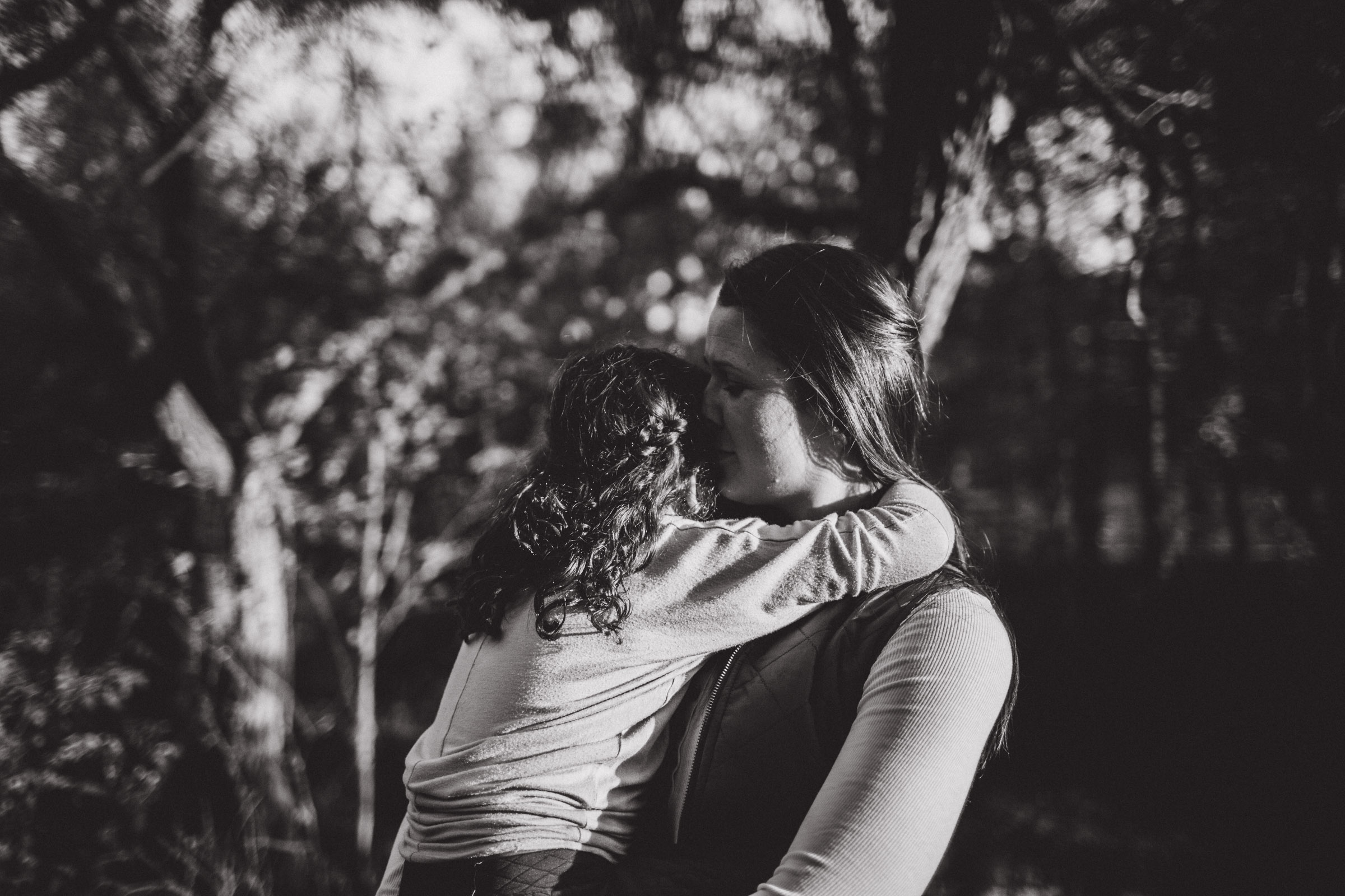 mother and daughter breathing each other in, black and white image 