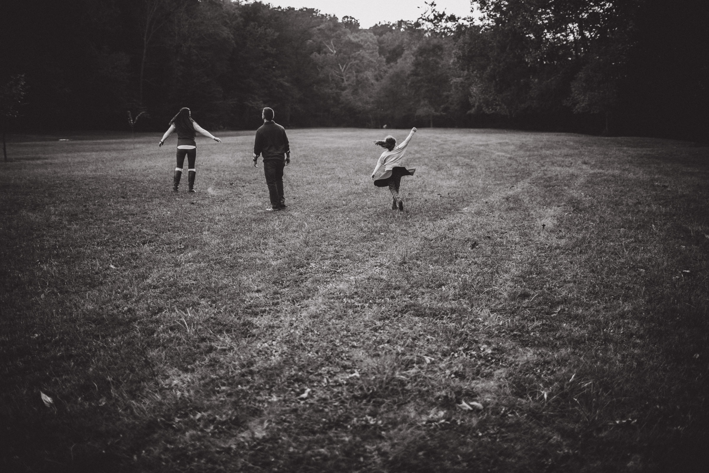 family dancing in fields 