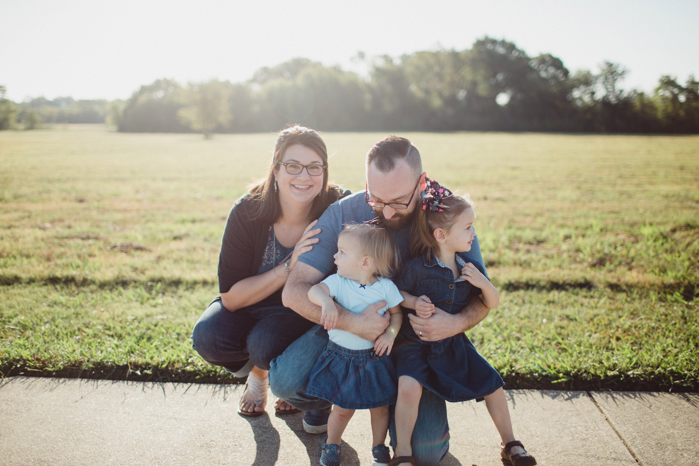 Family cuddled together in gorgeous light 