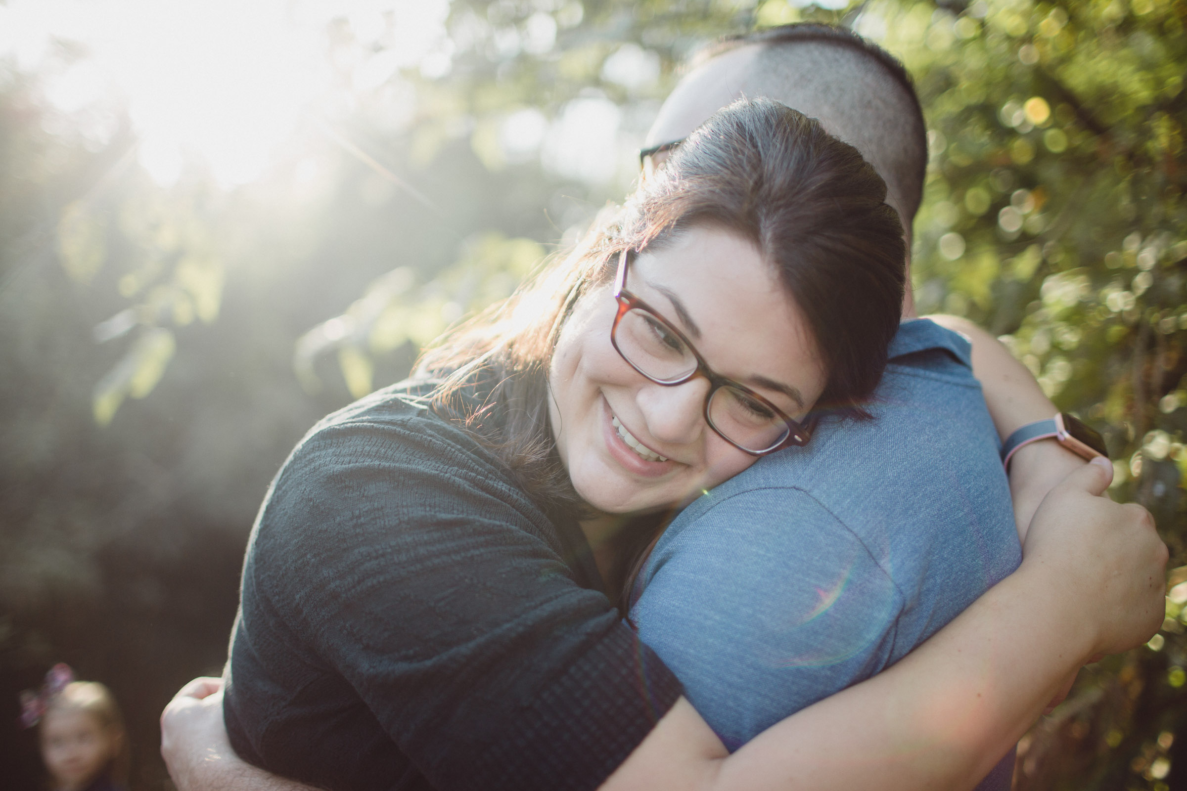 wife resting into husband's arms 