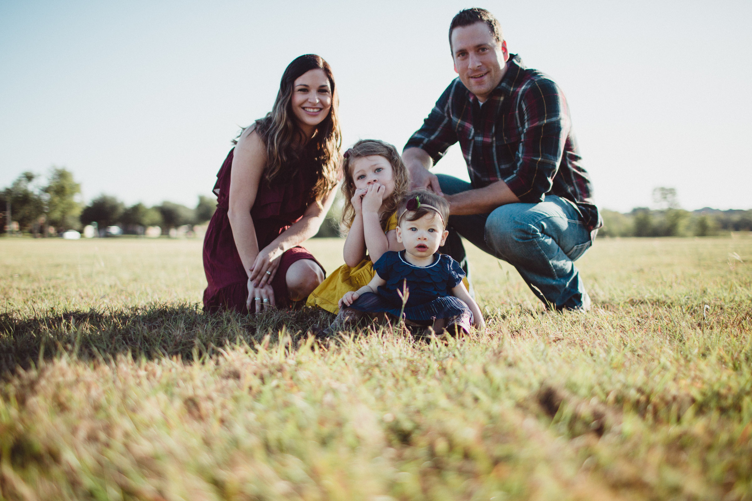 family together in a field 