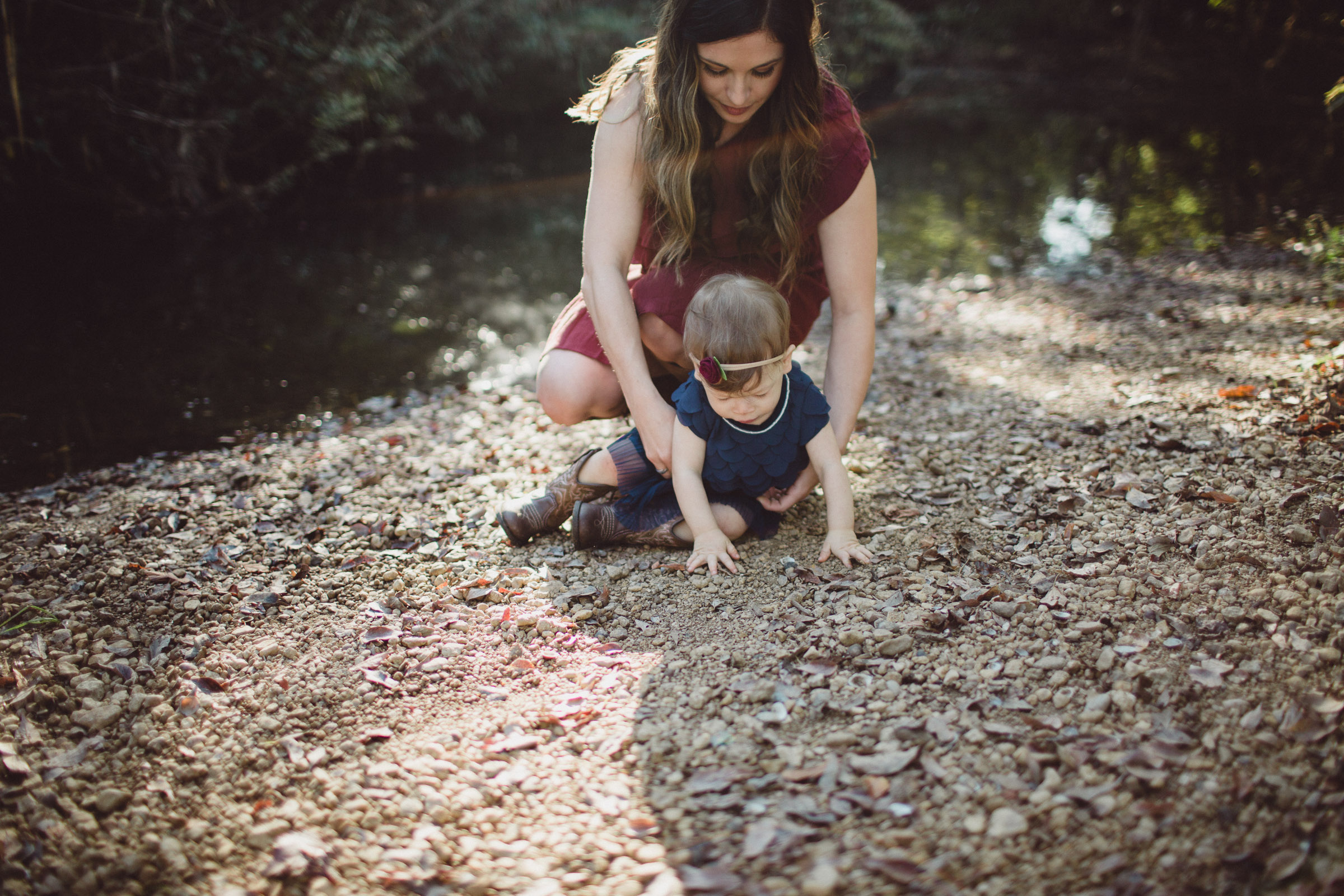 mother helping adjust the outfit of her daughter 