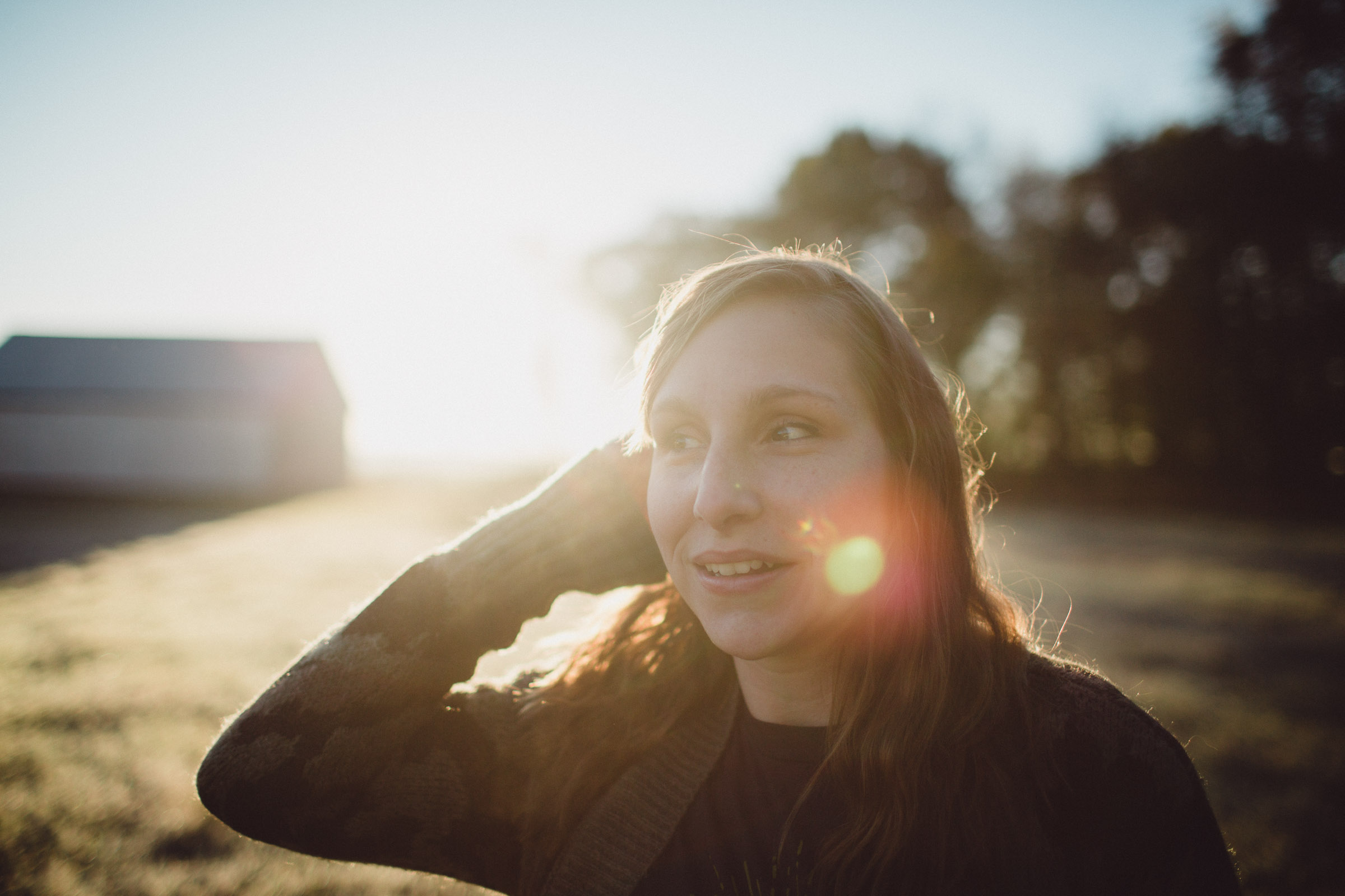 Portrait of girl with backlight and sun flares streaming in