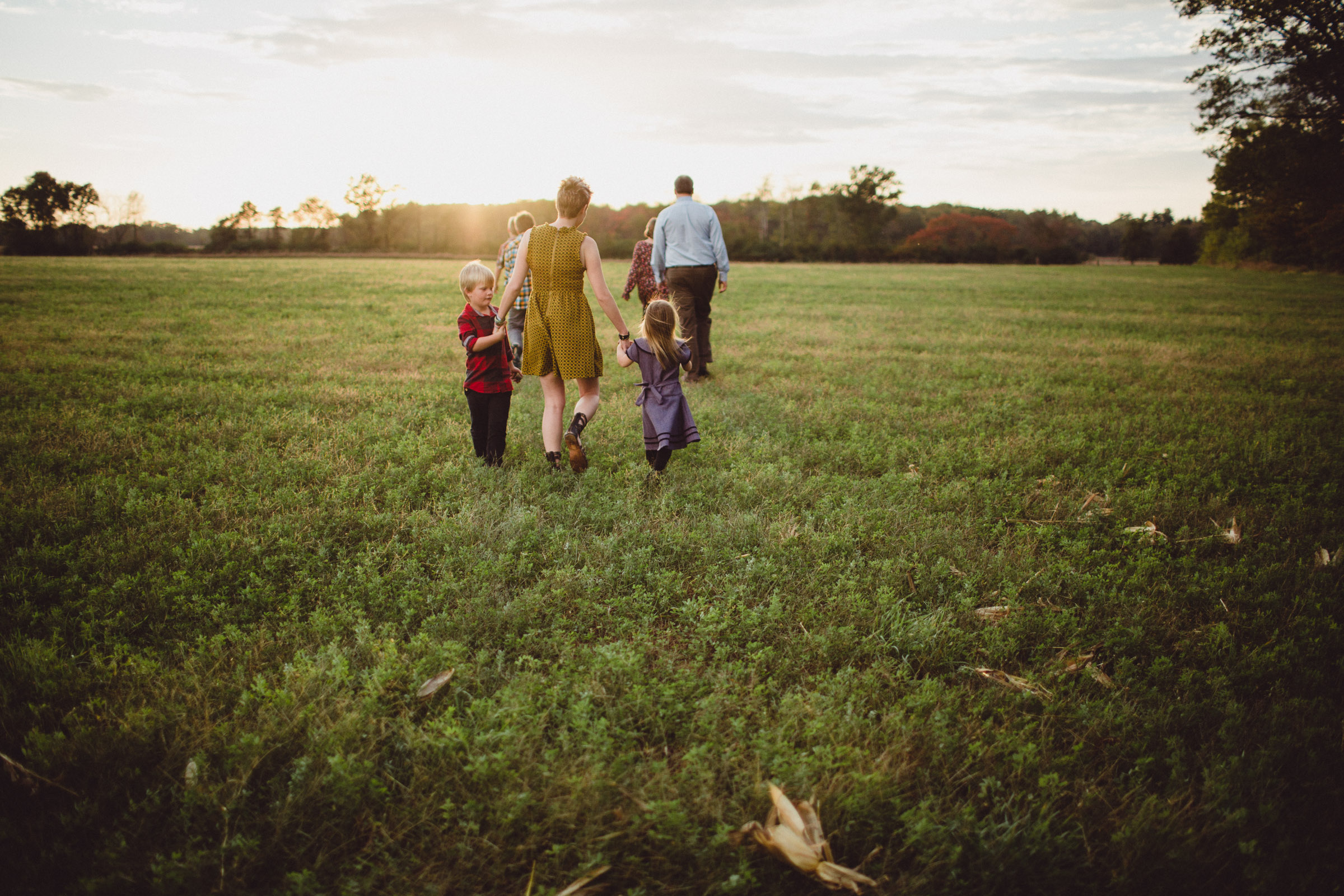 Family walking together into sunset