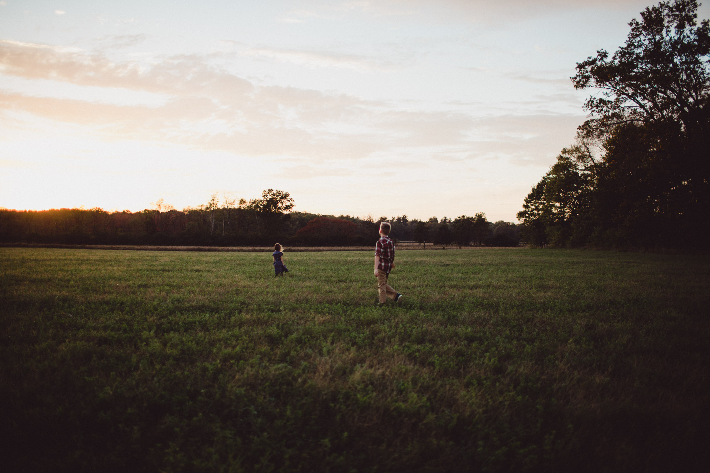 children running through field 