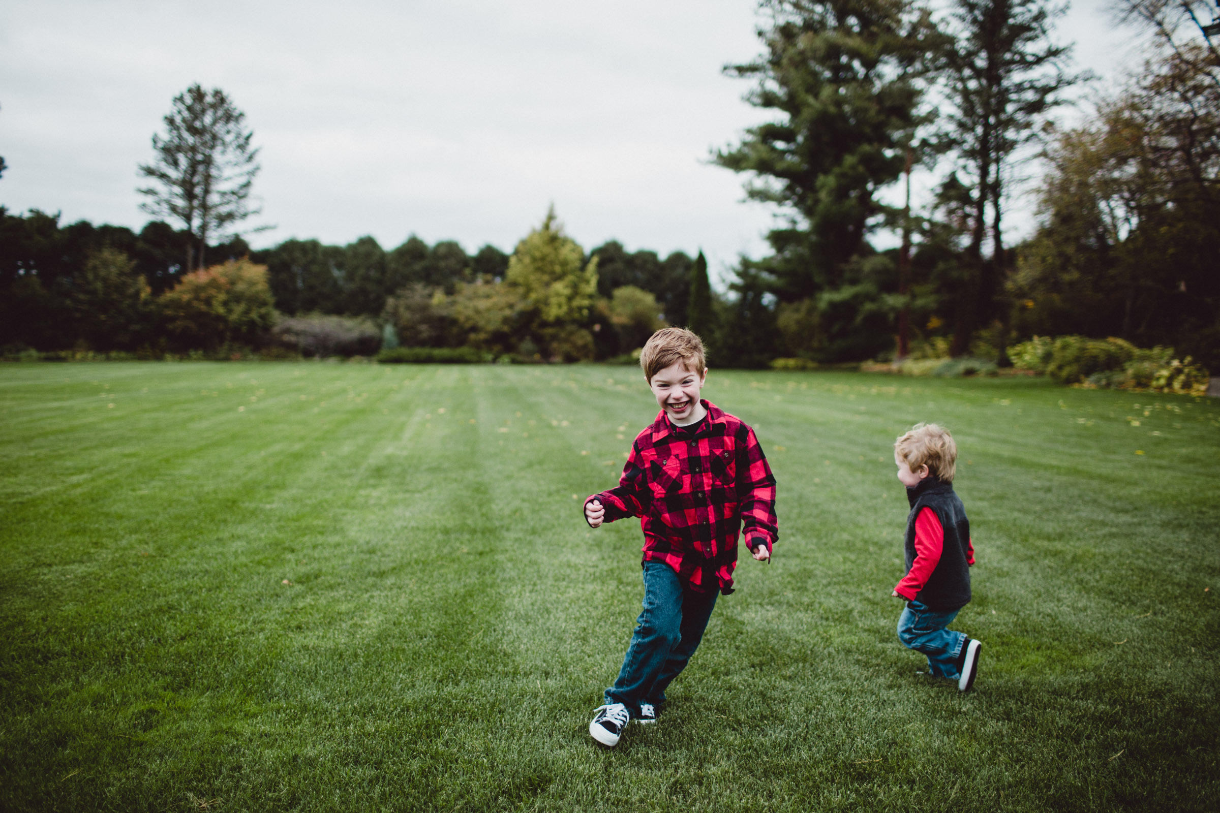 Brothers running through field together 