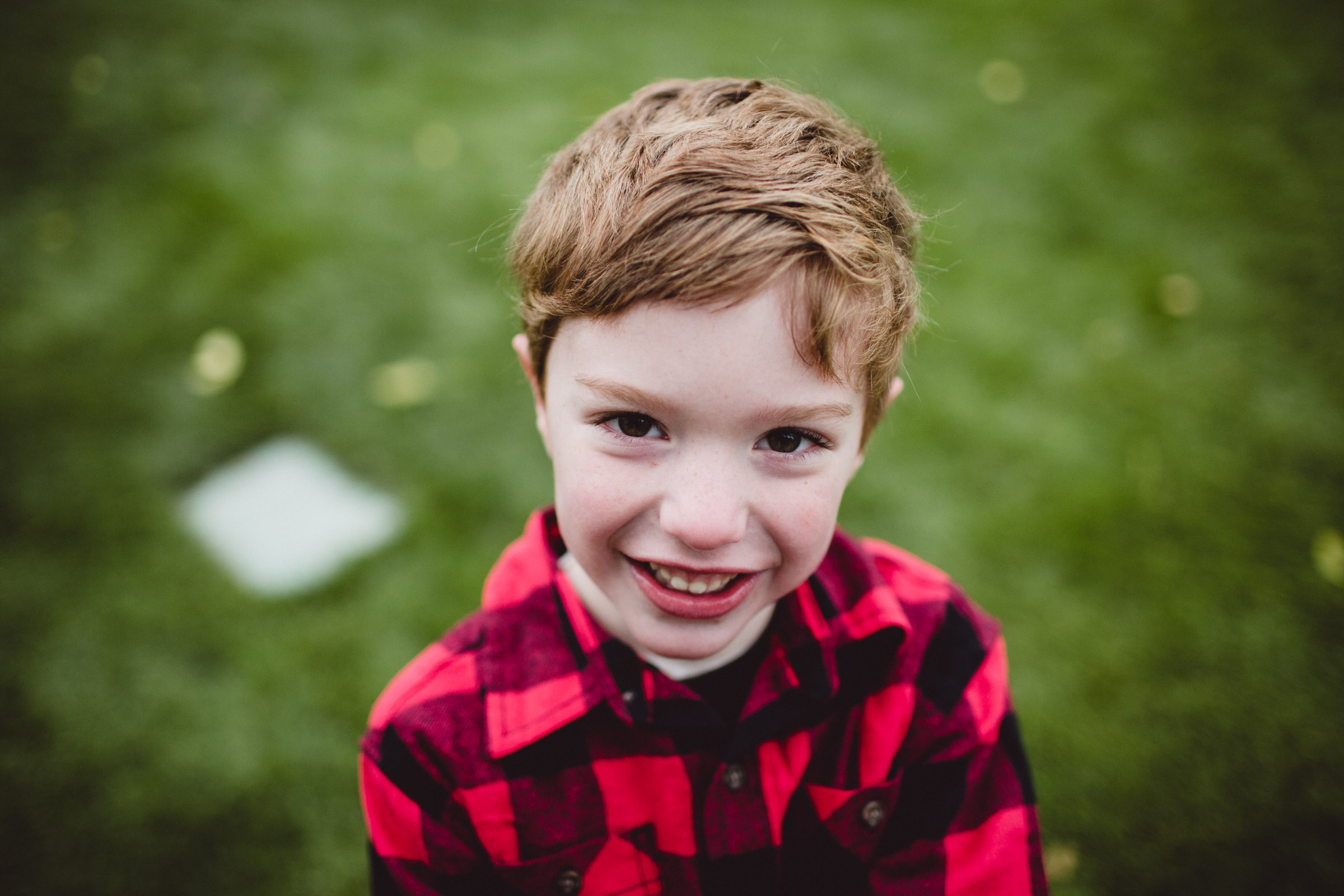 young son looking straight up into camera