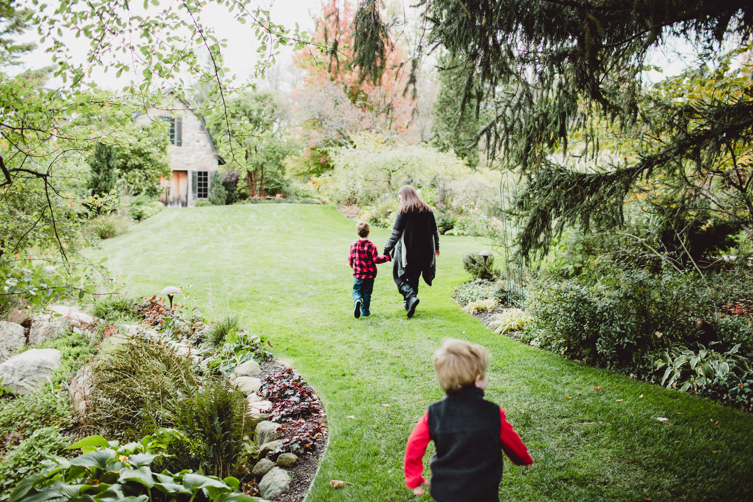 mother and son walking through the trees 