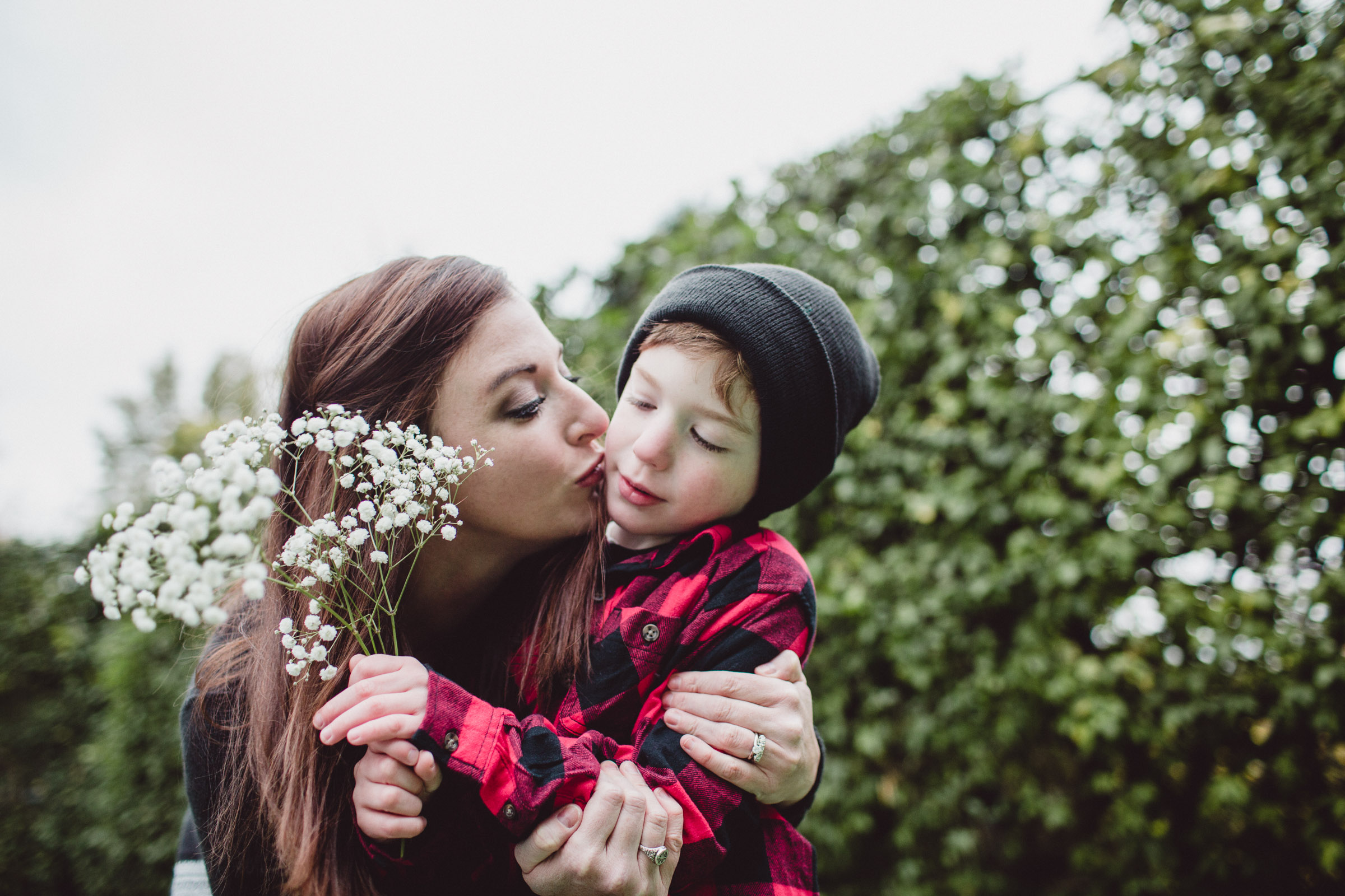 mother kissing her son's cheek 