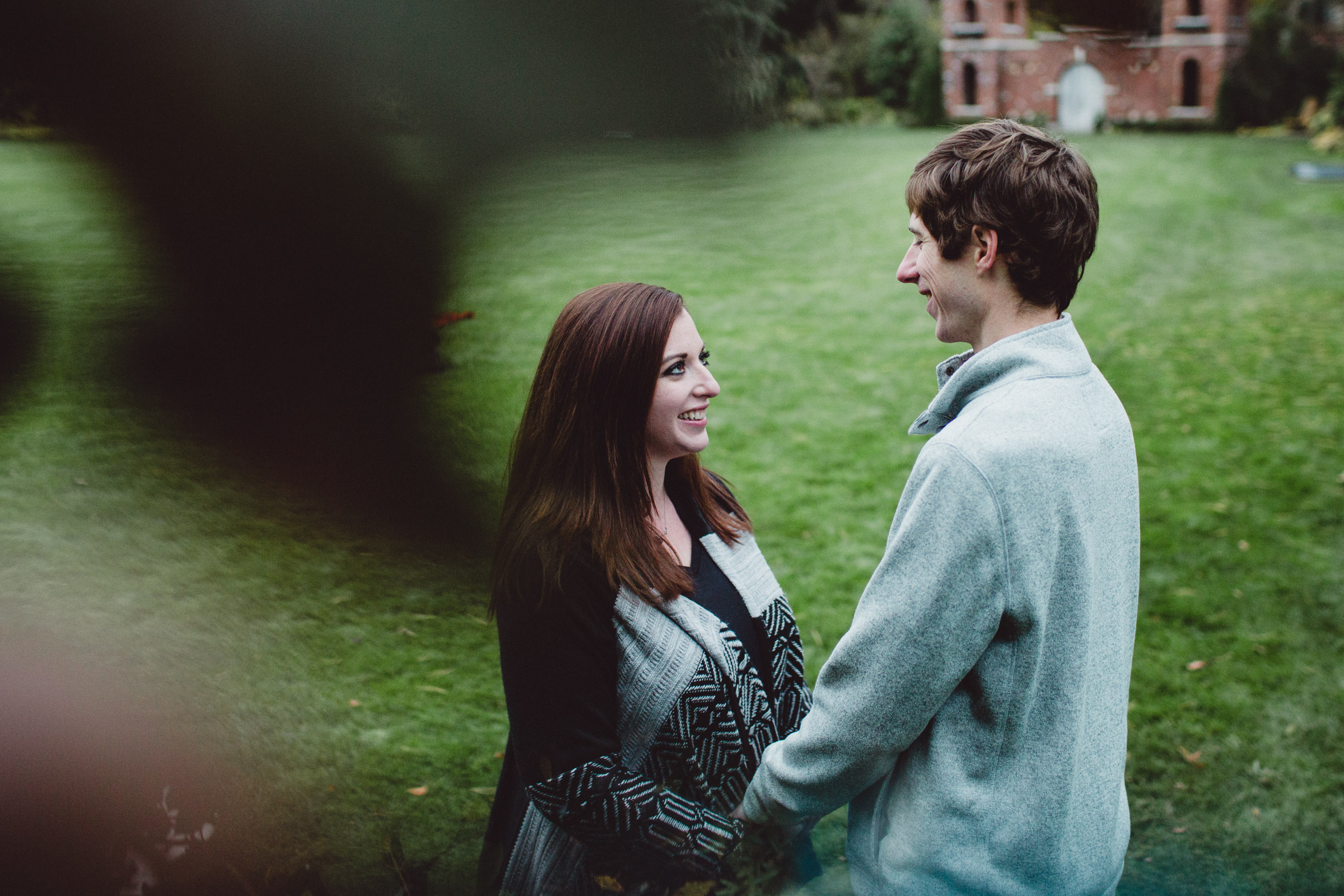 couple admiring each other through the trees 