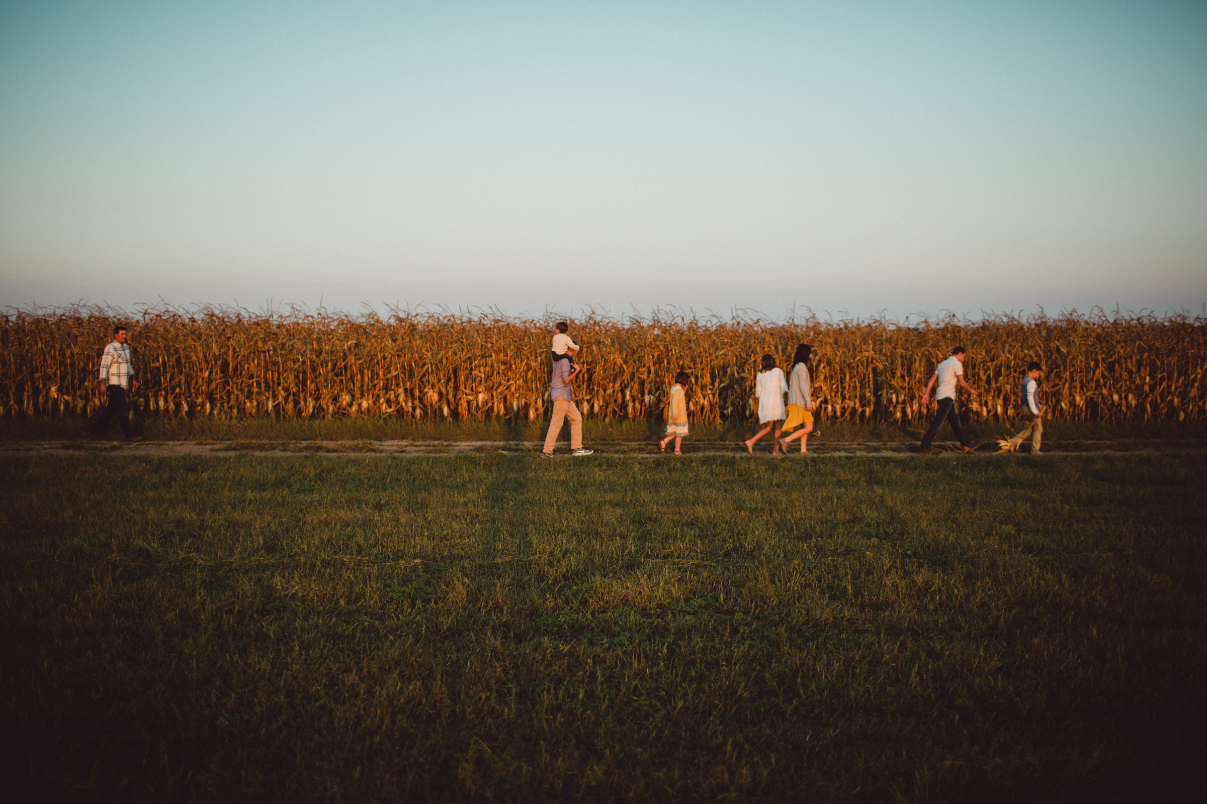 Family walking along a field together 