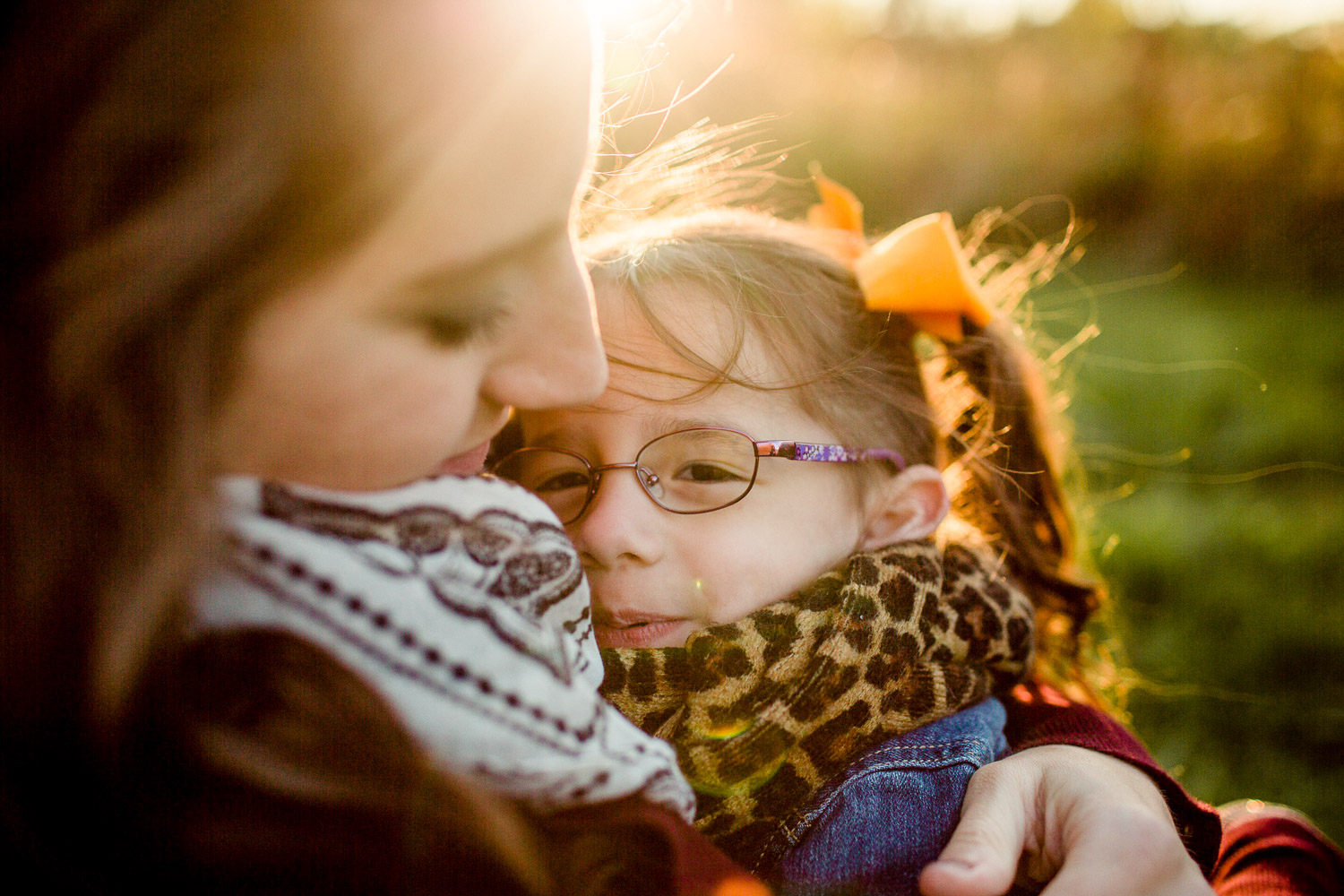 mother and daughter cuddled in close together 