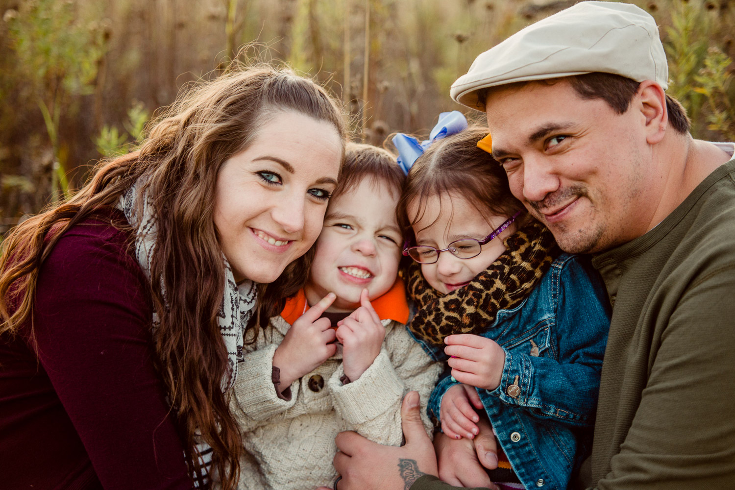 family with heads pressed together 