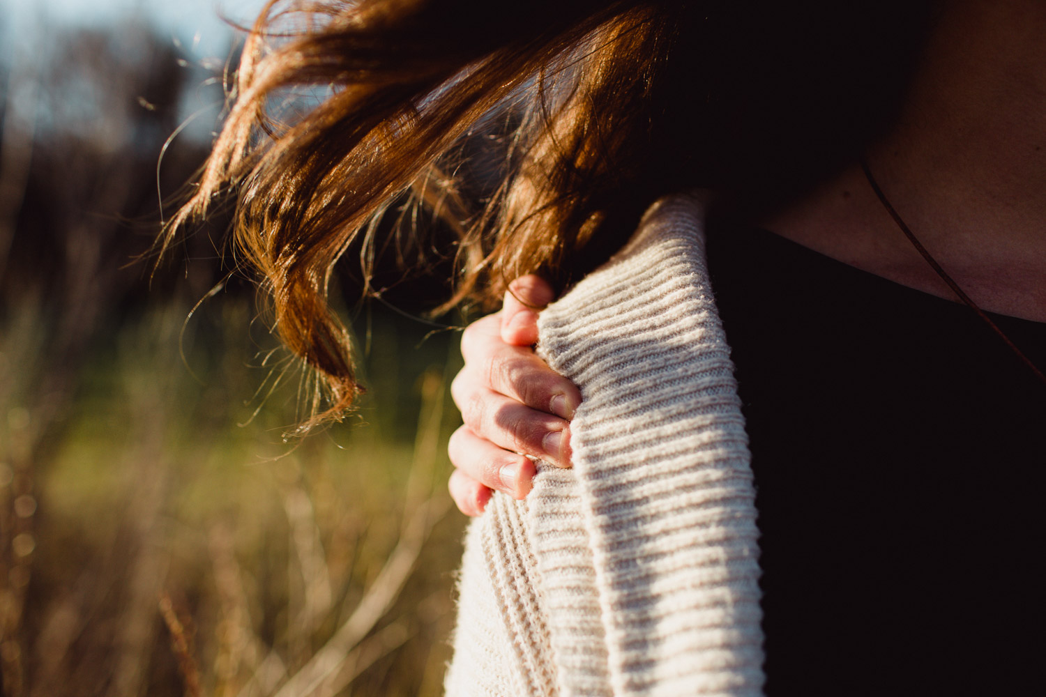 hand holding mother close, hair waving in the wind 