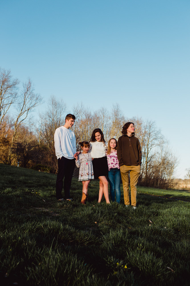 children gathered together in evening light