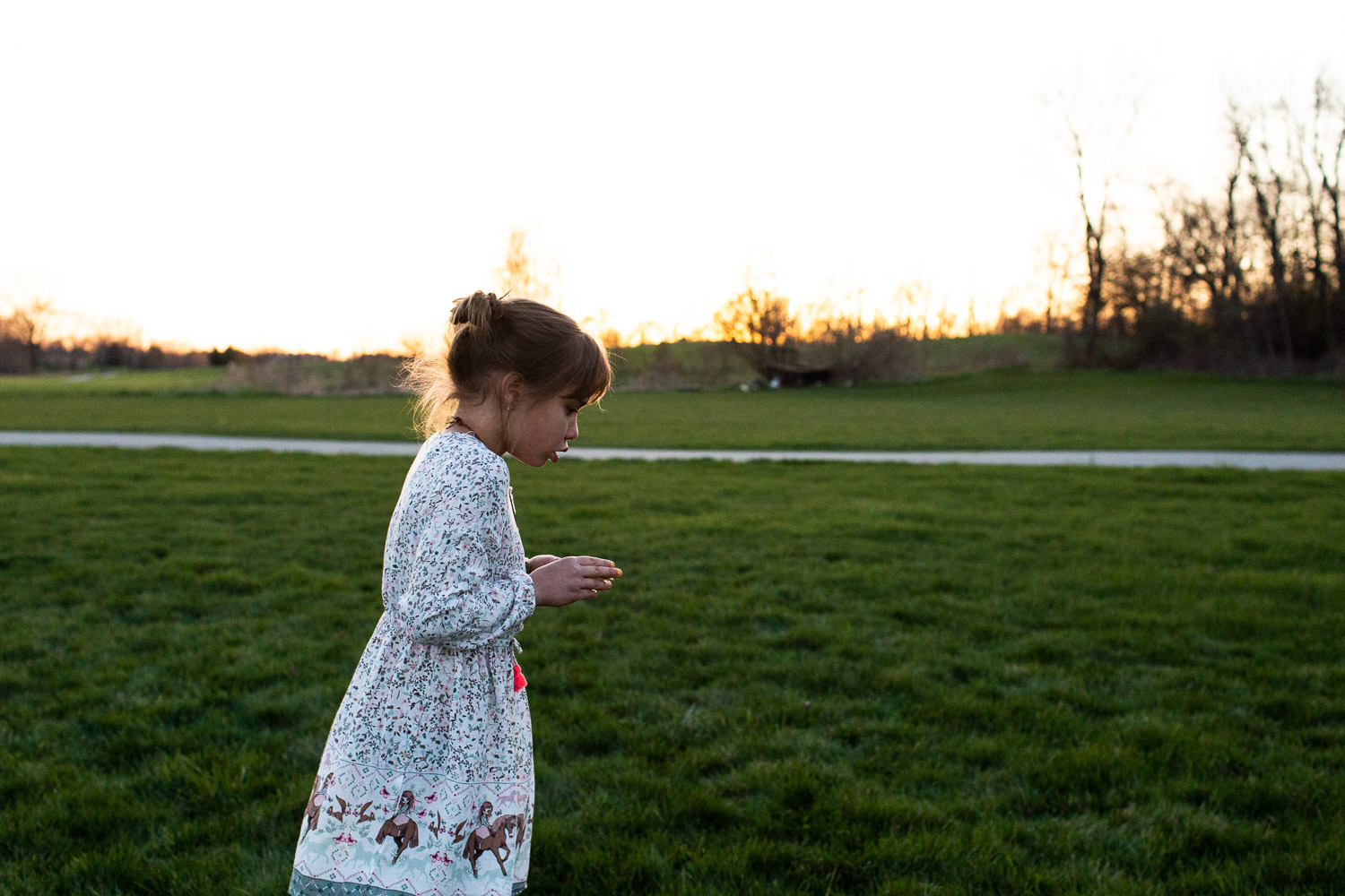 Girl walking along field