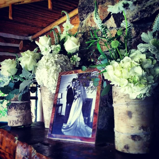 The mantle has photos and more arrangements. // #keystoneweddings